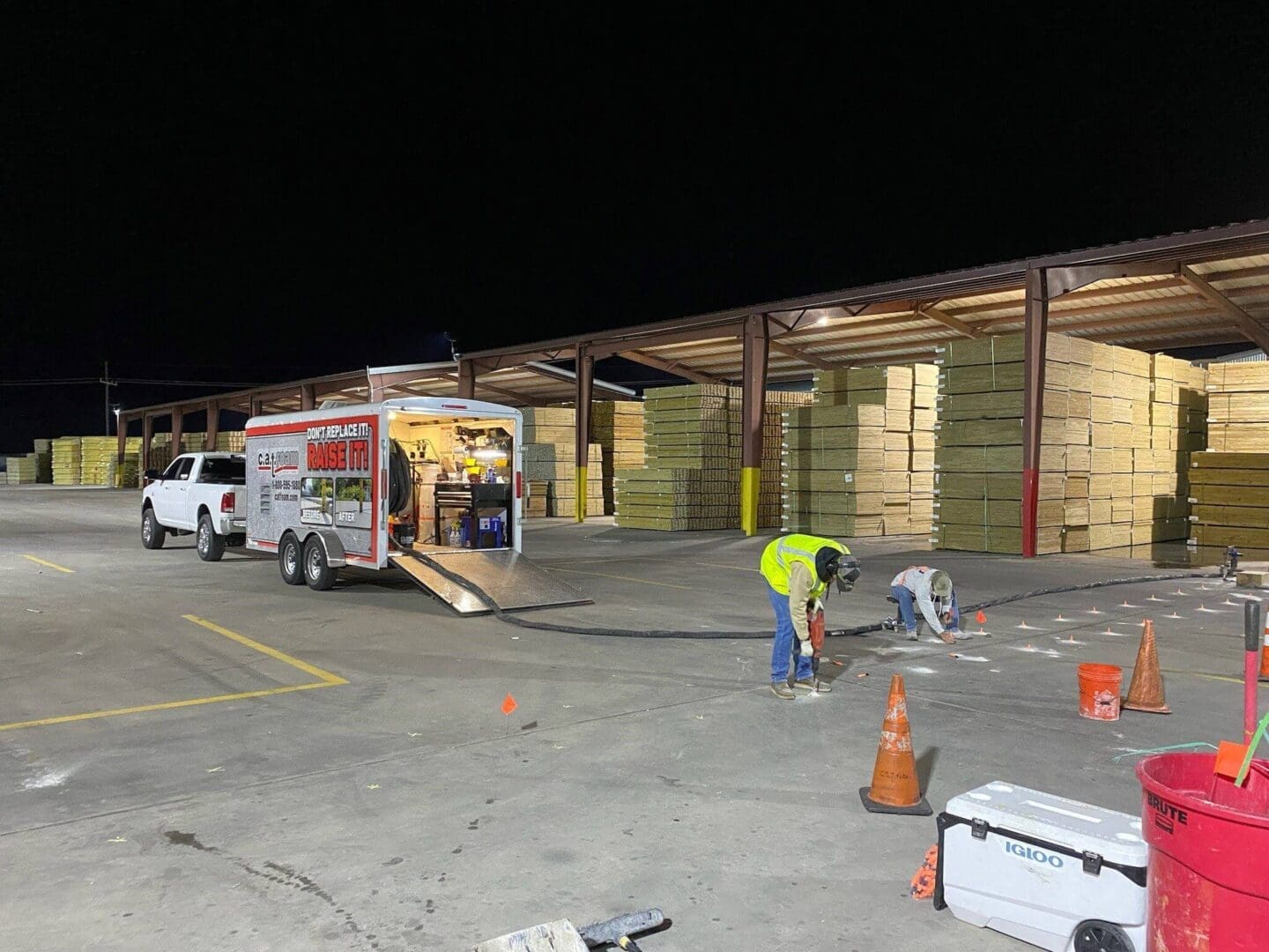 Workers at night in lumber yard.