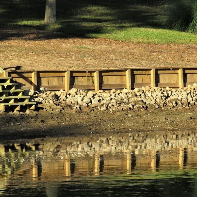 Wooden steps leading to a calm lake.